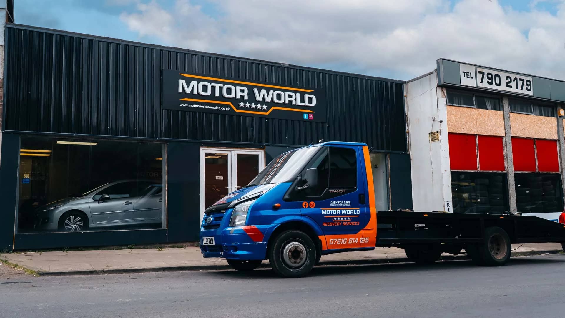 The MotorWorld unit with a branded truck outside