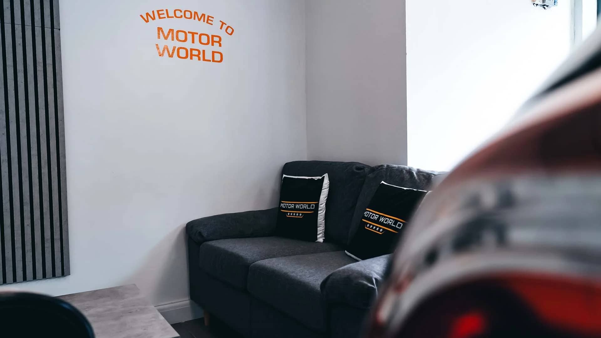 MotorWorld waiting area with sofa and signage