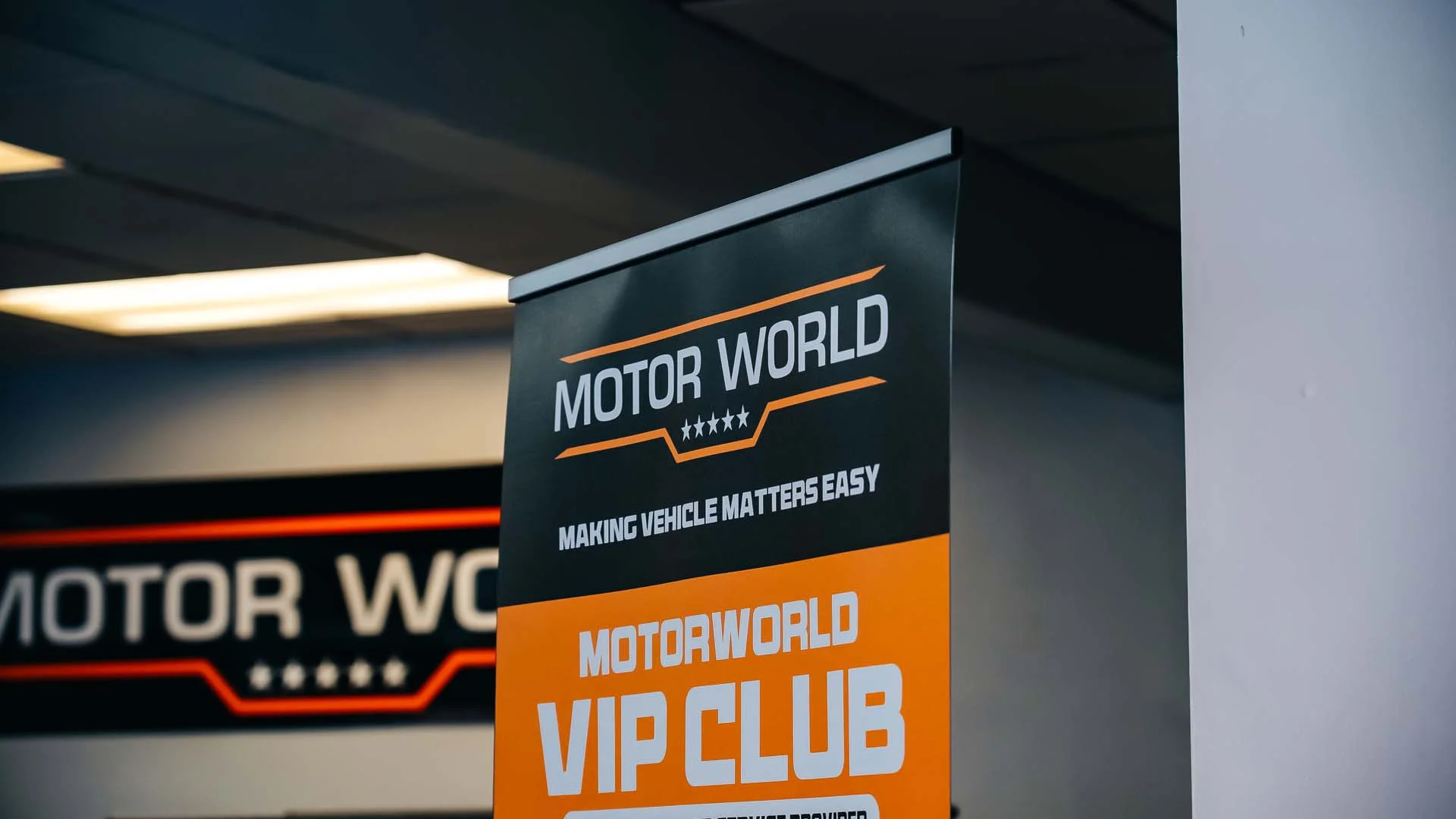 MotorWorld branded vertical banner inside the workshop